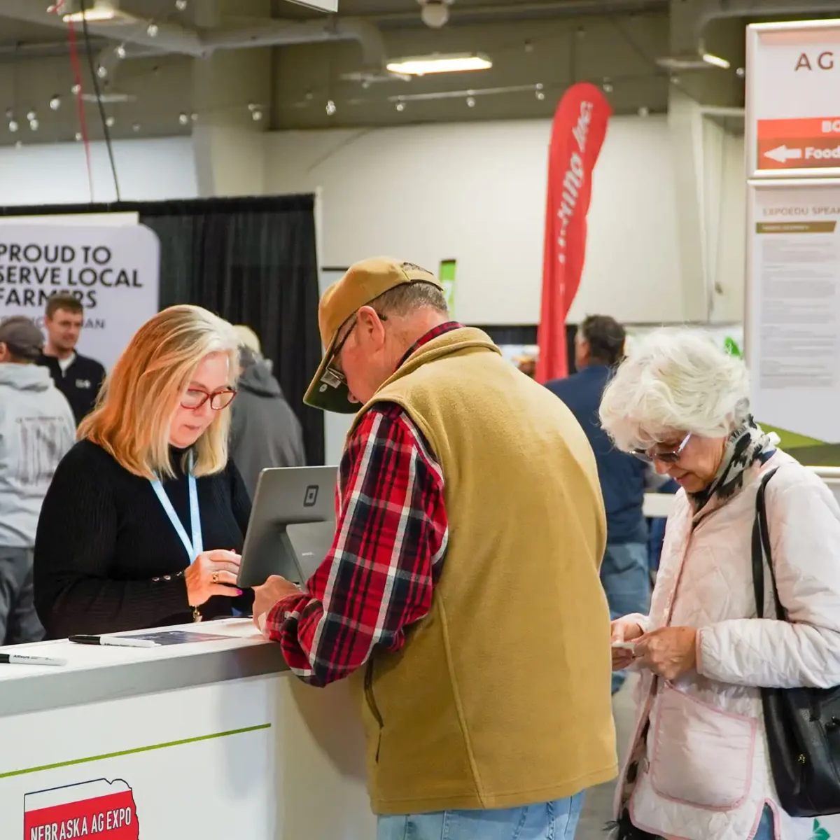 Two visitors checking-in to the Nebraska Ag Expo.