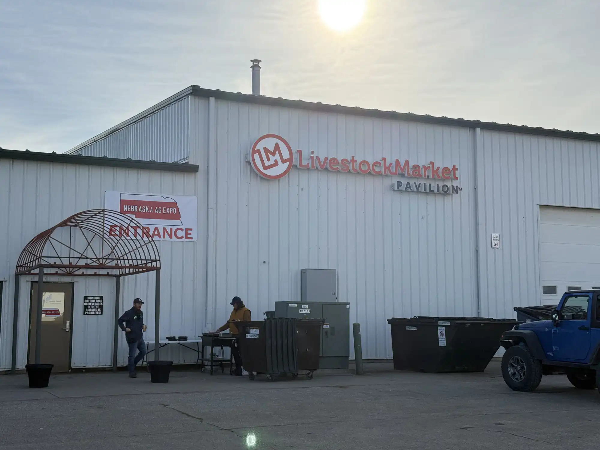 Exterior of a large warehouse building with LivestockMarket Pavilion written on its side.