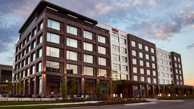 Exterior of The Scarlet Hotel beneath a blue and pink sunset sky